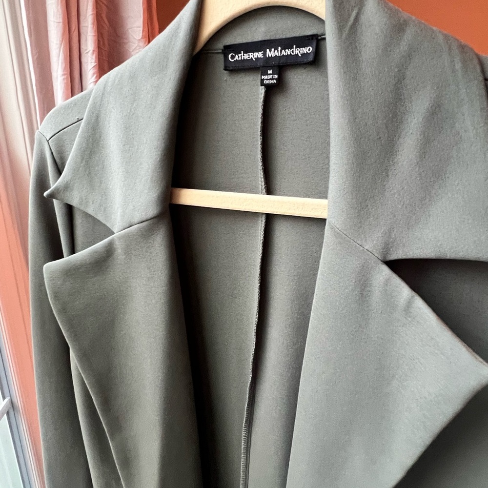 Long versatile duster coat in a muted green. Perfect for layering any season!